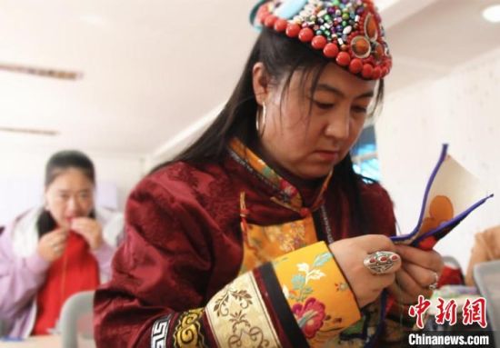 圖為裕固族婦女學(xué)習(xí)刺繡?！∈缝o靜 攝