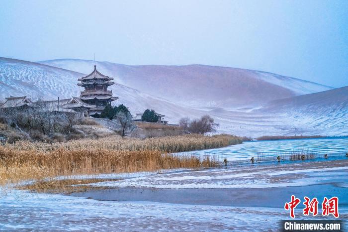 2021年11月28日，雪落鳴沙山月牙泉景區(qū)?！⊥醣筱y 攝