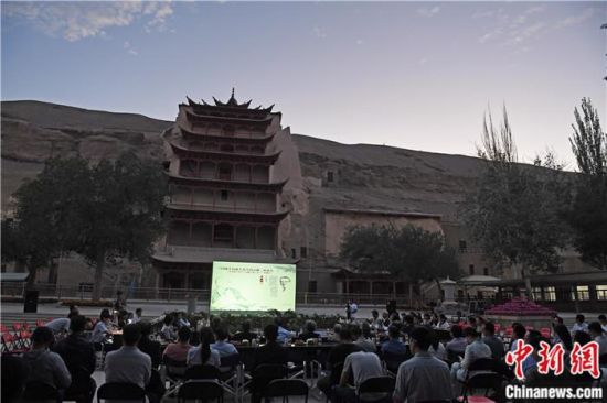 2018年8月，在敦煌莫高窟標(biāo)志性建筑“九層樓”前，《回顧平山郁夫先生的貢獻(xiàn)》座談會(huì)舉行。來自中日兩國的專家、學(xué)者共同懷念這位情系敦煌數(shù)十載的繪畫巨匠、中日友好的文化使者、世界文化遺產(chǎn)的守護(hù)者。中新社記者 楊艷敏 攝