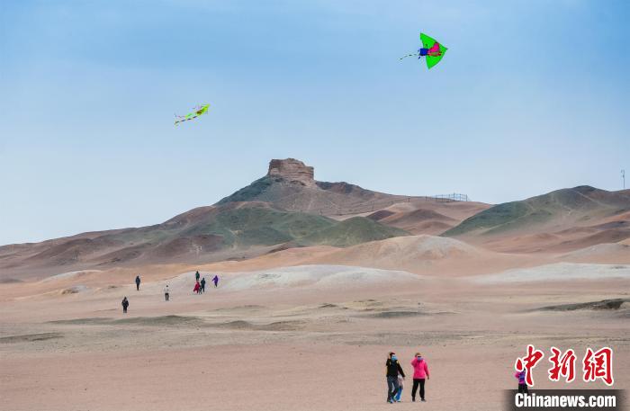 圖為市民正在陽關(guān)景區(qū)放風(fēng)箏。　王斌銀 攝